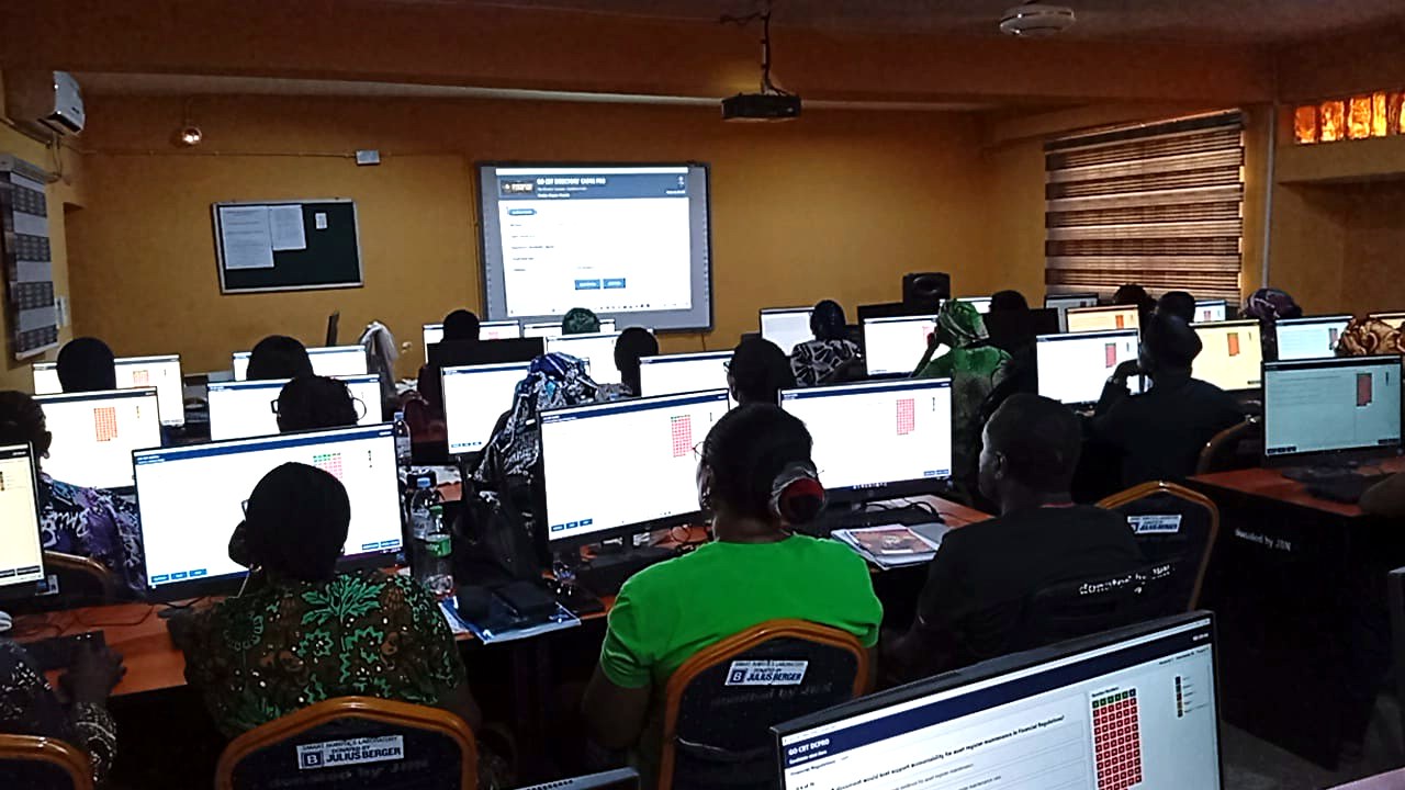 A large group of candidates practising with computers during a GO WORLD CBT session